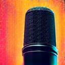 Microphone against a vibrant, graffiti-style backdrop with dynamic lighting